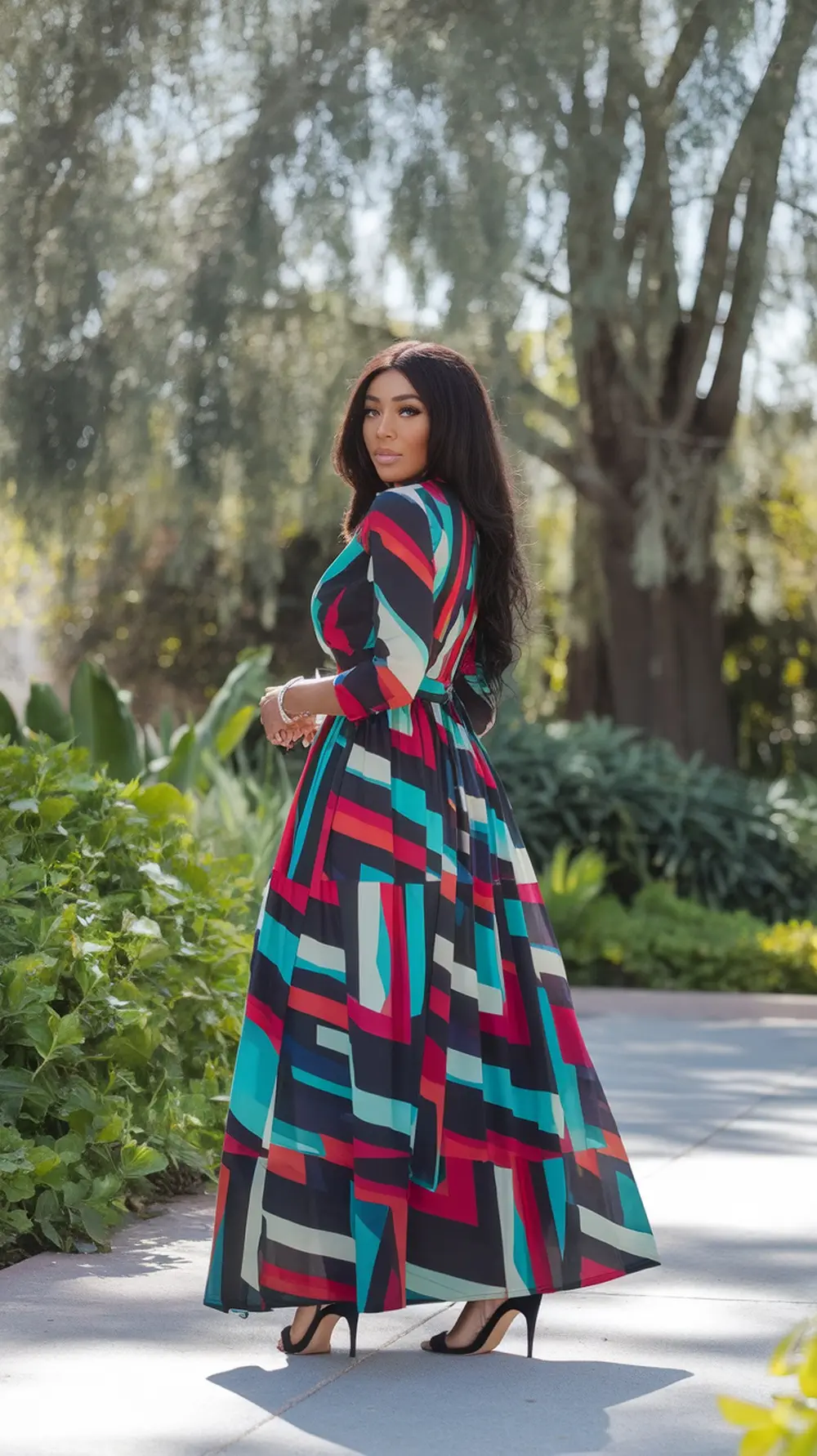 A woman in a colorful maxi dress stands outdoors, showcasing a vibrant print and chic style.